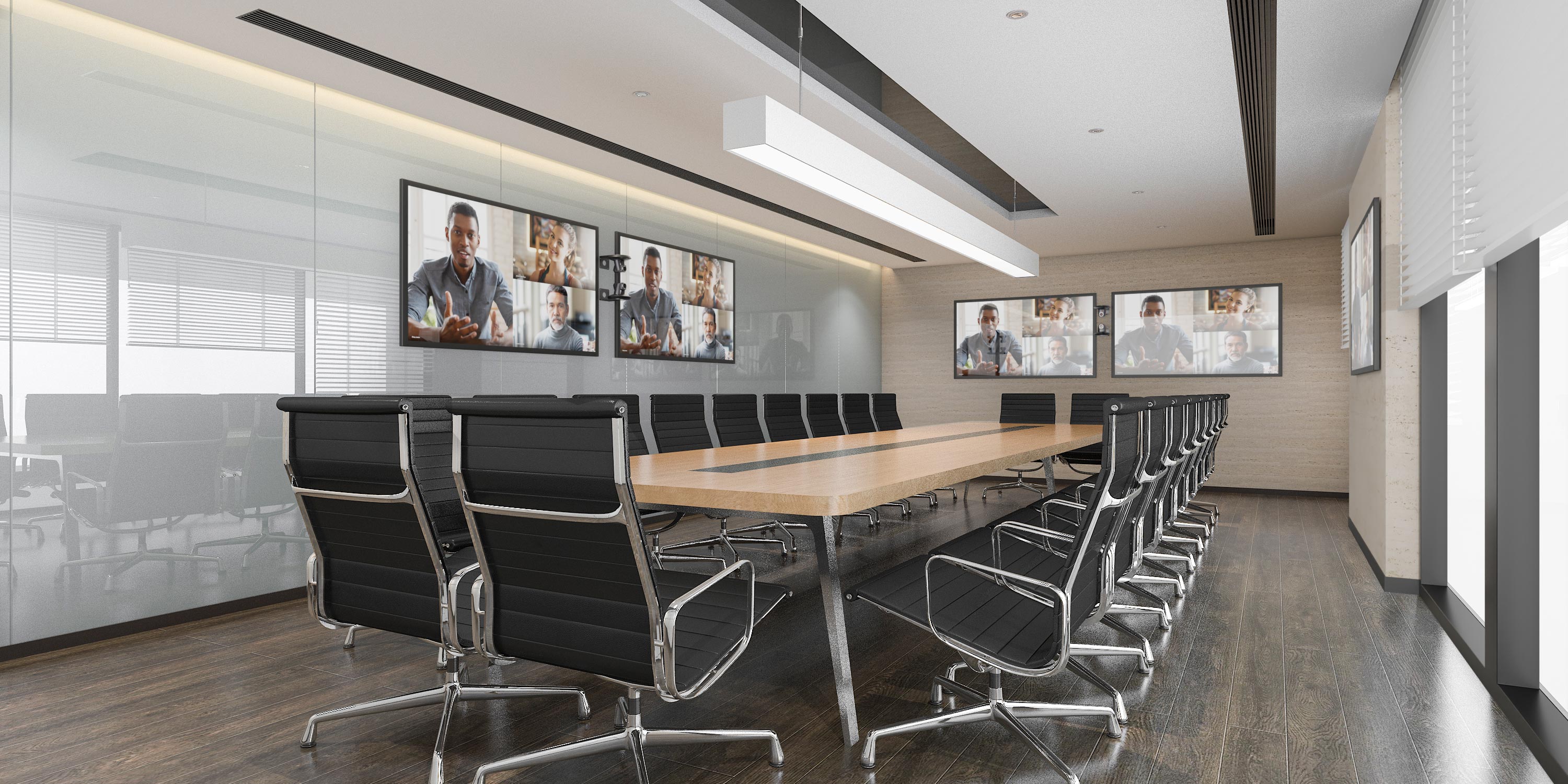 Modern conference room with long table, black chairs, and large video screens
