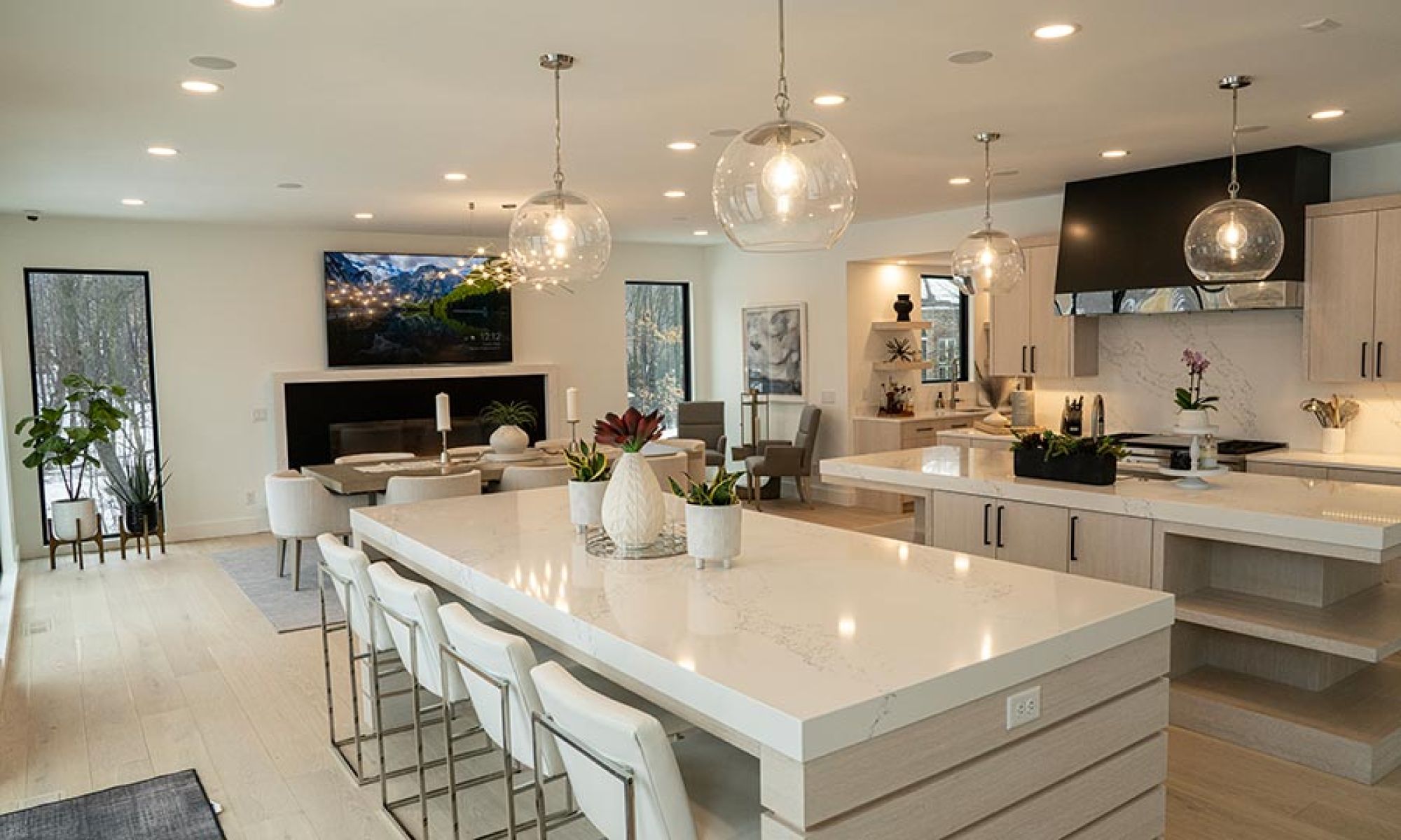 Open kitchen and living space with recessed speakers and lighting