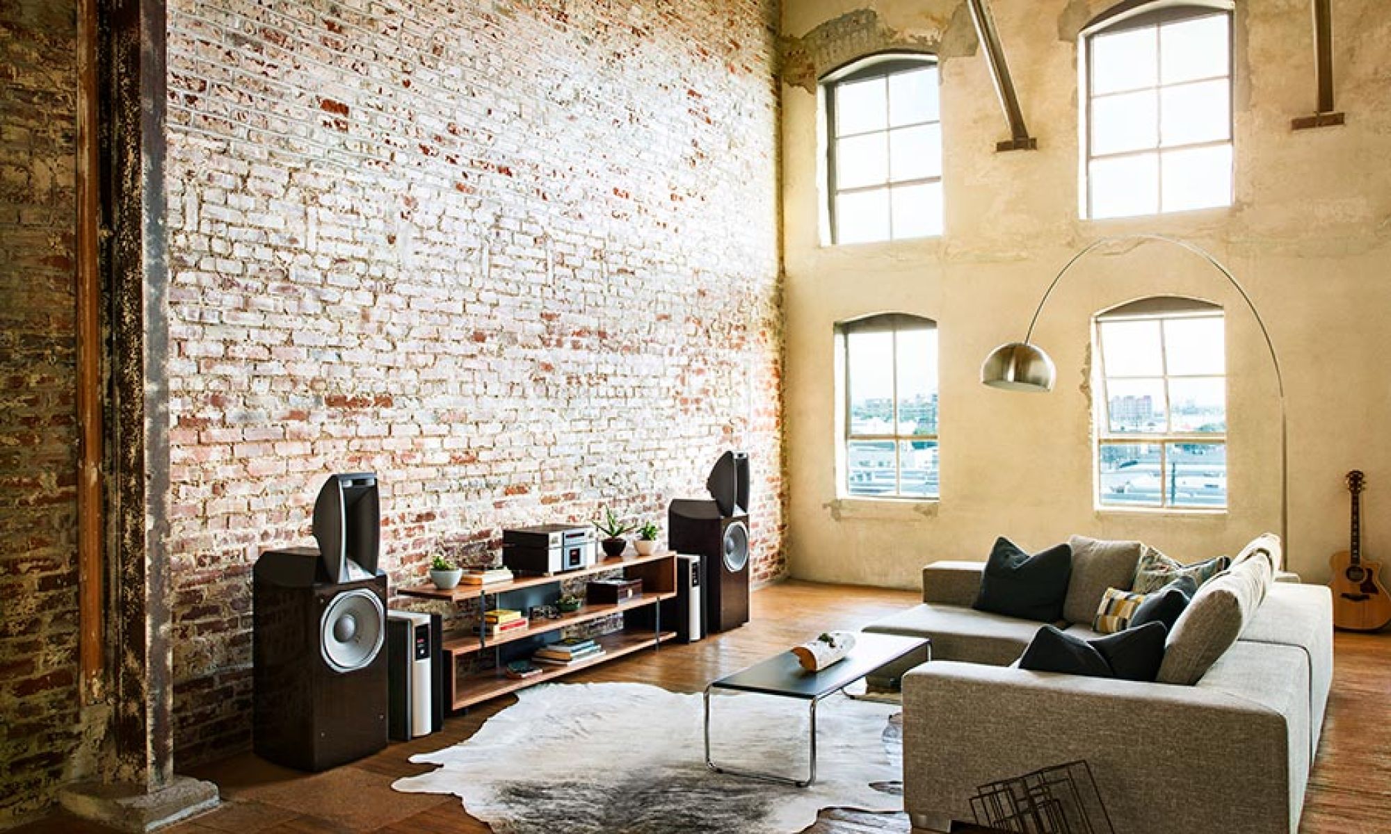 Living room audio setup with large speakers and modern furniture